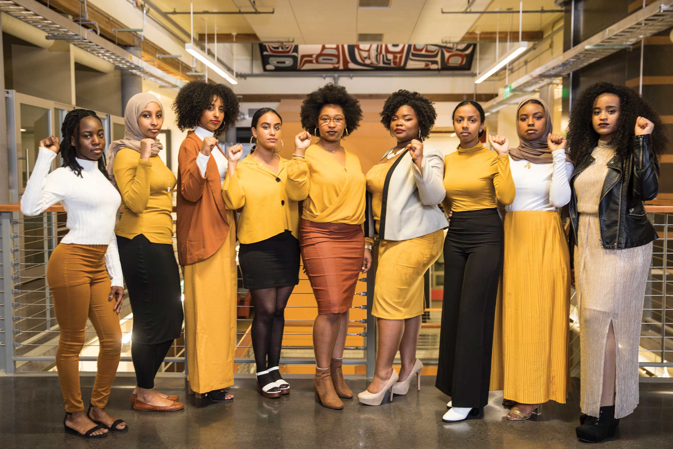 Group of women students with fists raised